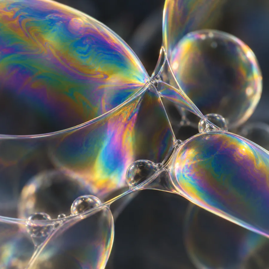 Thin-Film Interference Render: Subtle rainbow interference shifting across translucent curved films, delicate edges and physically suggestive optical color.